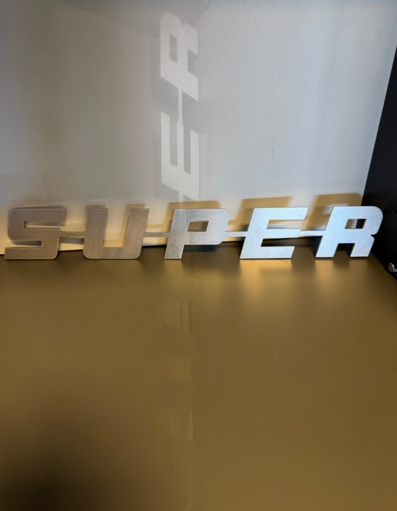 Super emblem i rustfritt stål